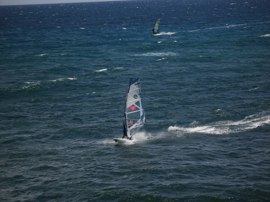The sandy shallow beach of Bahia Feliz is most famous for windsurfing