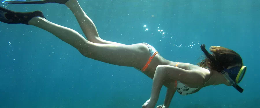 A Snorkeller dives down to the sea floor to explore underwater in Arinaga in the Canary Islands
